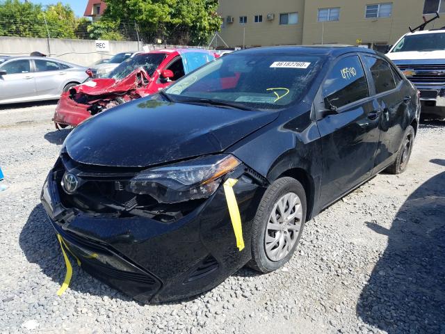 Photo 1 VIN: 5YFBURHE0KP879011 - TOYOTA COROLLA L 