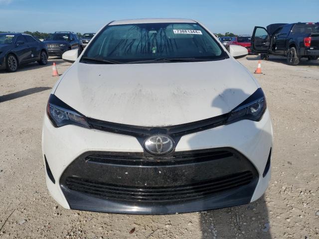 Photo 4 VIN: 5YFBURHE5KP869185 - TOYOTA COROLLA L 